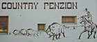 Country penzion - malba na  fasádě budovy.