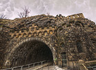 Nejstarší (zprovozněn koncem r. 1904) a nejkratší (délka 32 m) silniční tunel v pražské metropoli. Vede skrz Vyšehradskou skálu a spojuje Rašínovo a Podolské nábřeží. Portály tunelu jsou romanticky upraveny jako středověké cimbuří.

